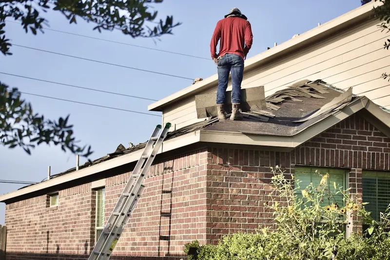 Professional roofer working on a residential roof in Michigan Beach